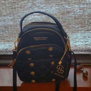 Small fashion back pack. Black in color two compartments.